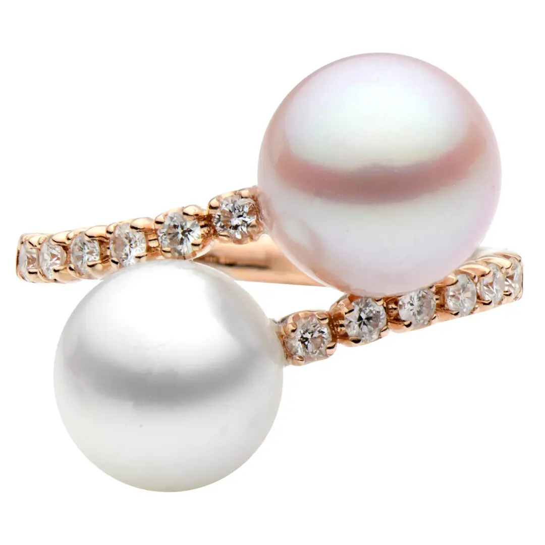 A white pearl and diamond ring on a rose gold band.