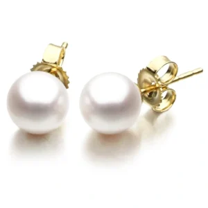 A pair of white pearls on top of gold colored posts.