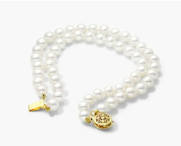 A white pearl necklace with gold clasp.